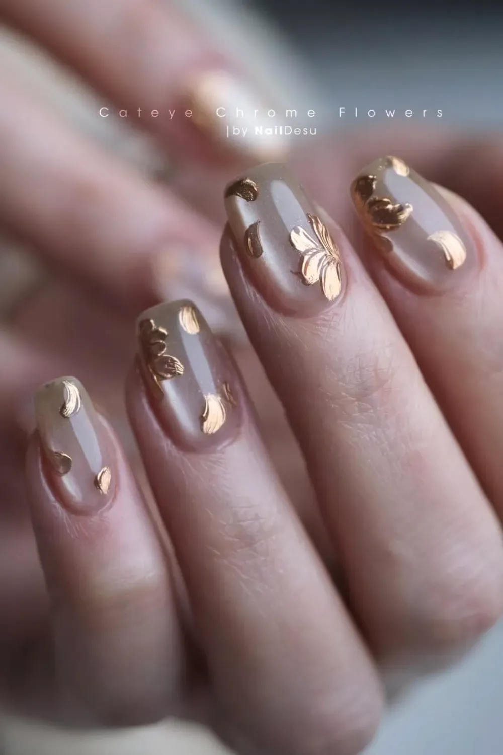 Nude short nails with delicate gold magnetic chrome floral petals.