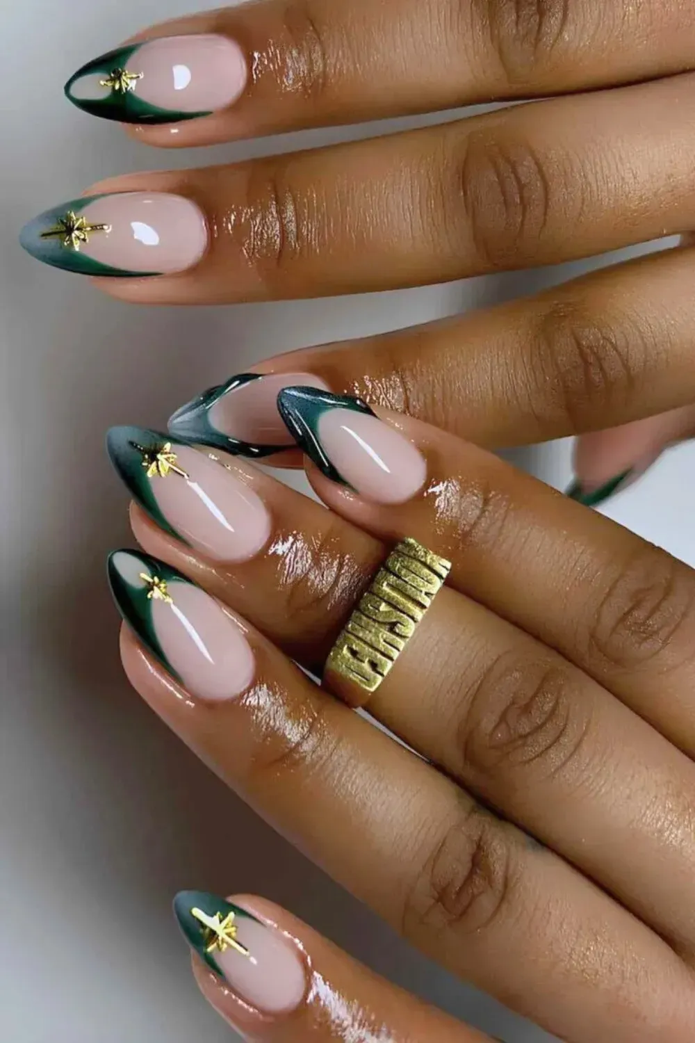 Dark Pine Green Celestial French Tip Nails - Long almond nails with dark pine green French tips with a gradient, accented by a small gold star charm.