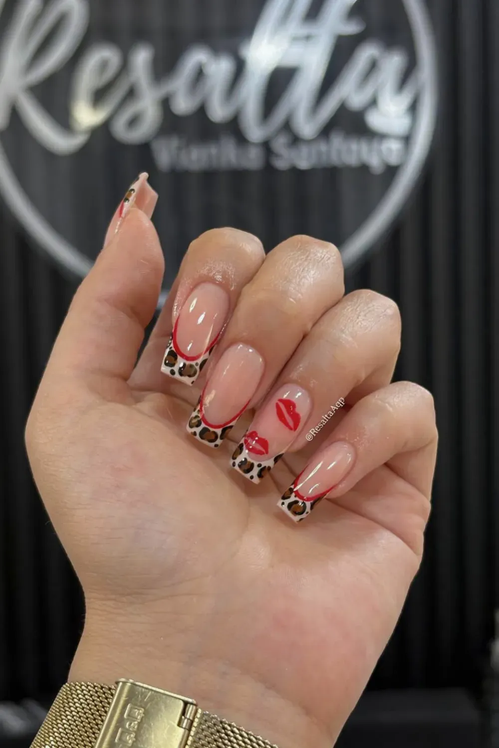 Leopard And Kiss Nails Alt Text: Leopard print french tips with red lip kiss marks