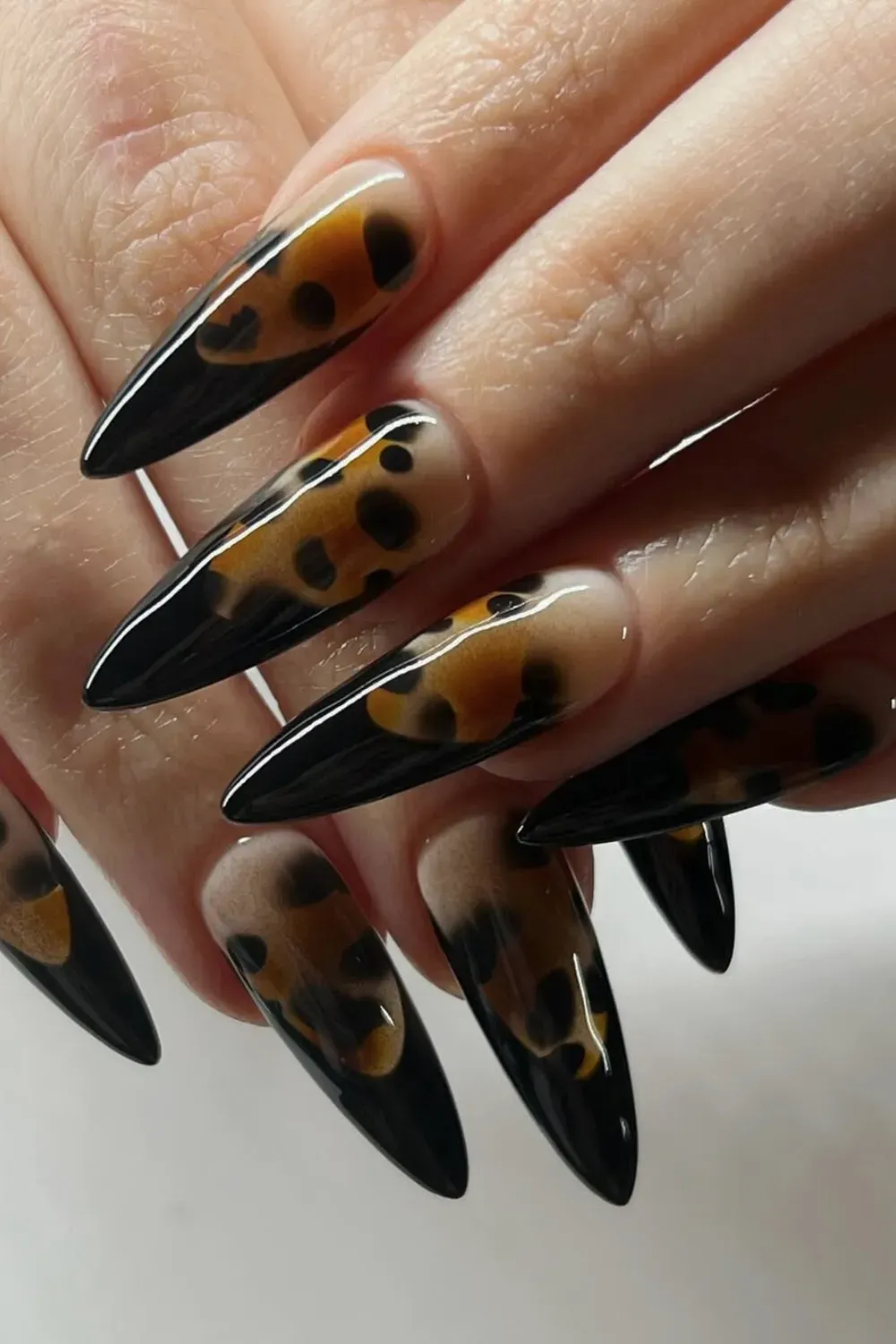 Amber Tortoise Print Stiletto Alt Text: High gloss stiletto nails with realistic amber tortoise shell tips.