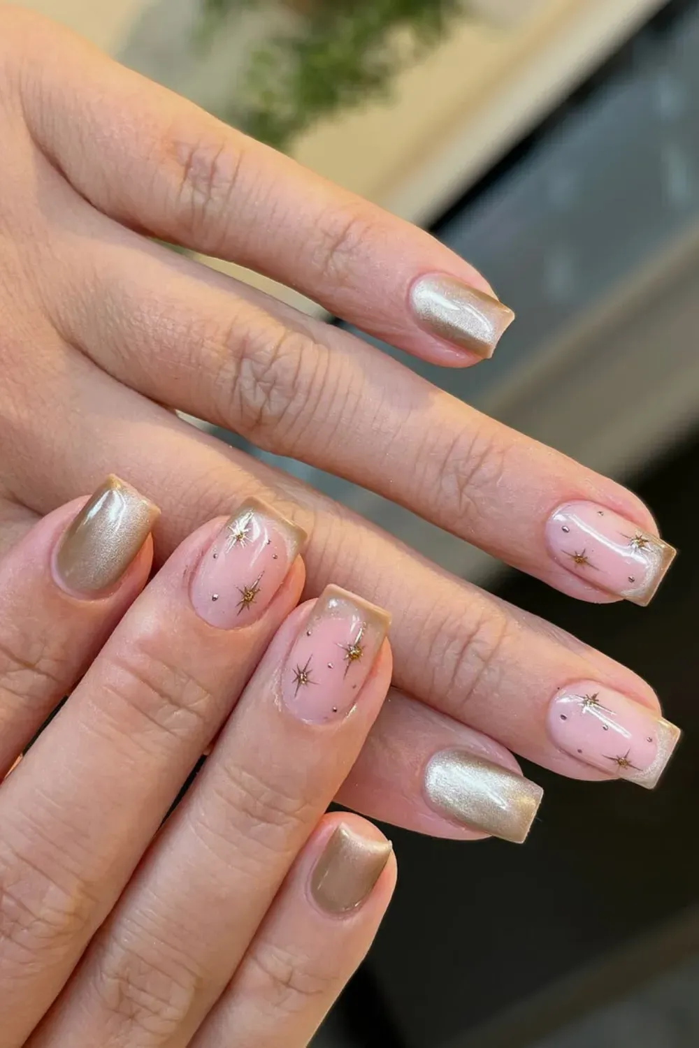 Mix and match short manicure with gold cat eye french tips and pink nails with stars