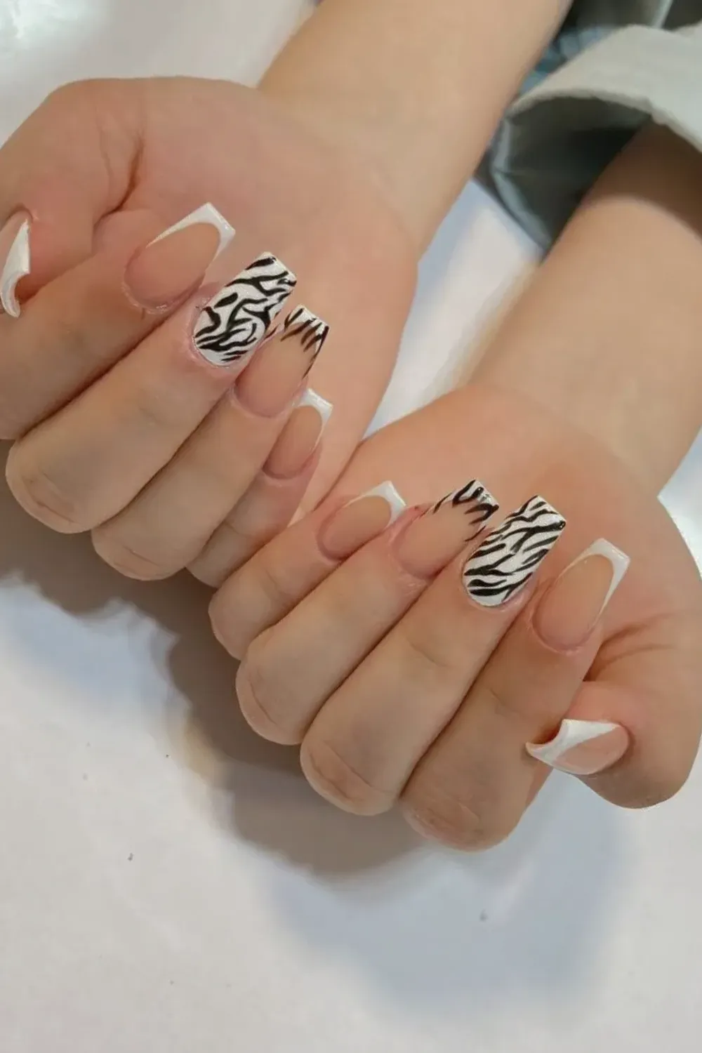 Short Zebra French Tips Alt Text: Medium coffin nails with black and white zebra print tips.