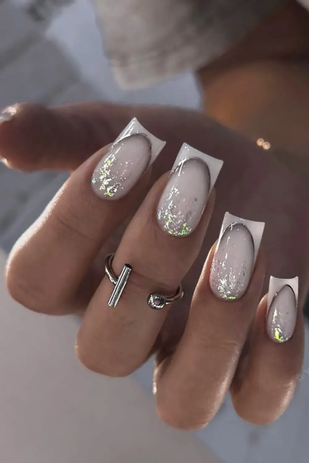 Silver Cat Eye French Alt Text: Square nails with white tips overlaid with silver cat eye polish.