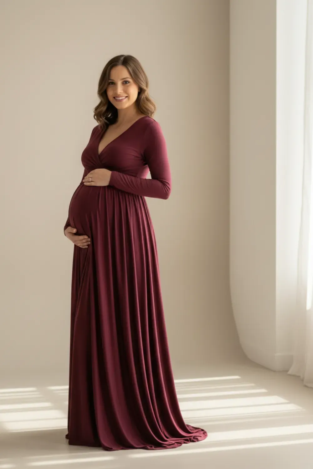 Bridal/Maternity full-length burgundy V-neck jersey gown with long sleeves.
