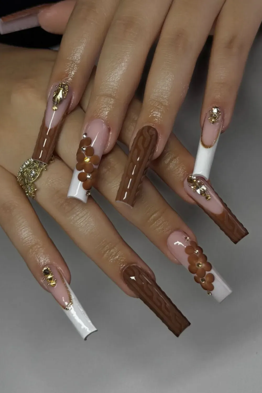 Brown Sweater Knit Nails Alt Text: Brown 3D sweater texture nails with flower accents.