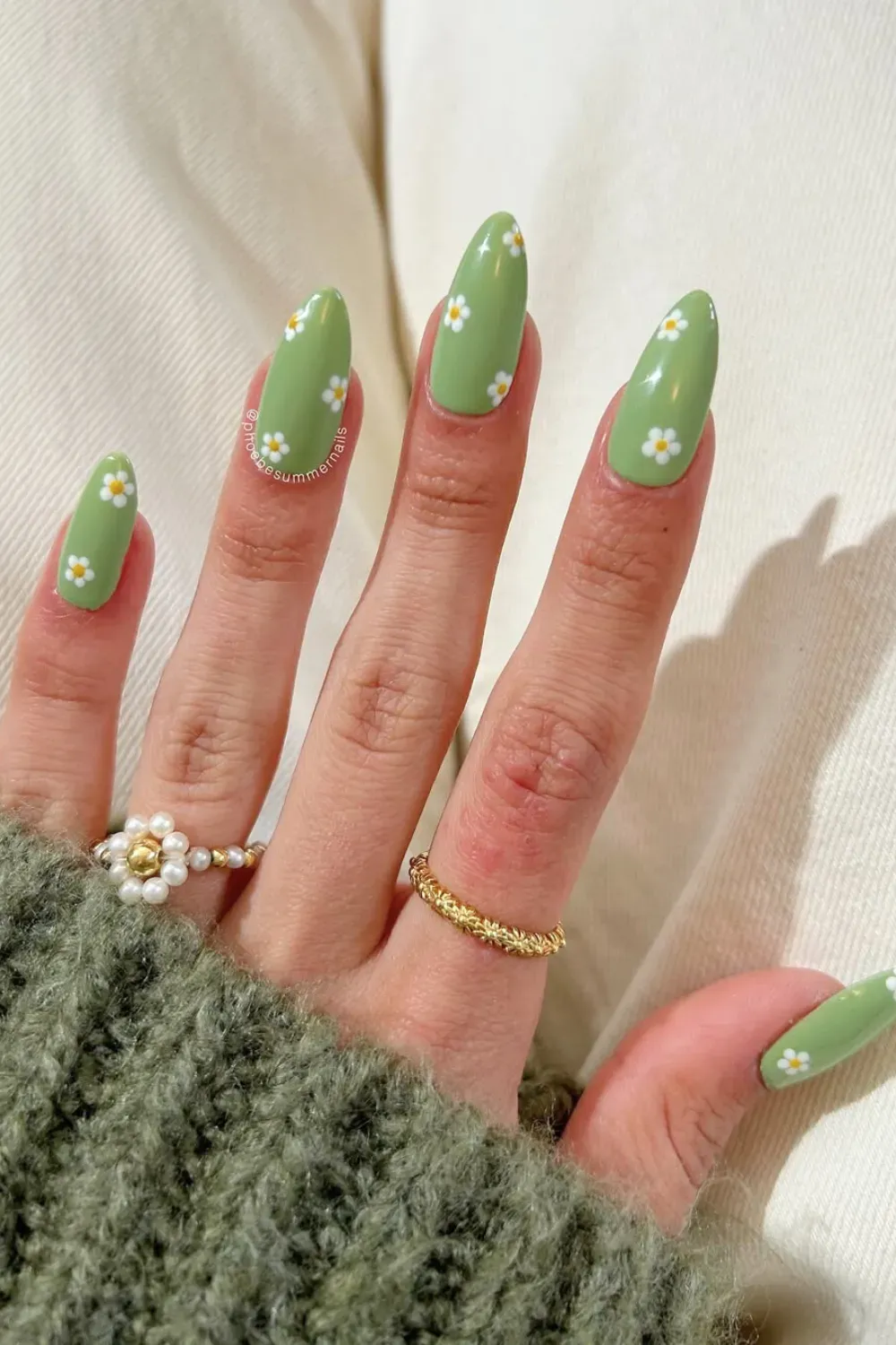 Daisy Flower Art on Bright Green Almond Nails - Long almond-shaped nails painted bright green with small white daisy flower accents.