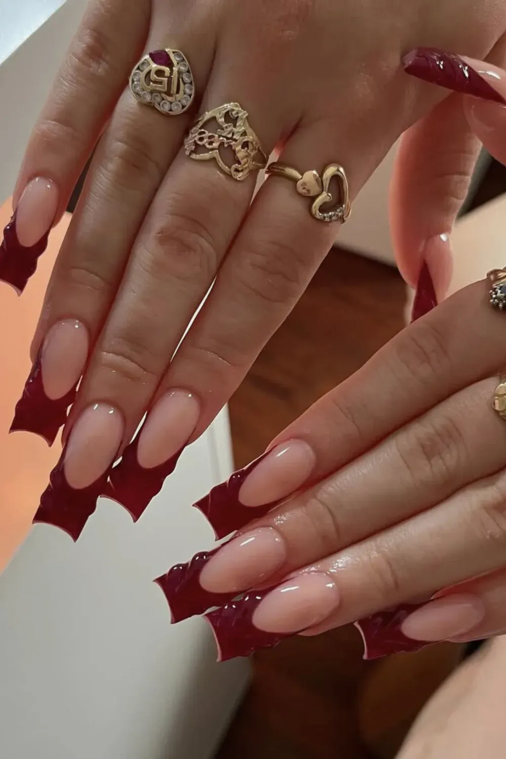 Wavy Burgundy French Nails Alt Text: Long coffin nails with textured wavy dark red french tips