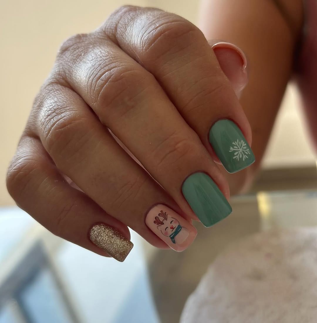 Short Squoval Mint Green Snowflake Nails - Short square nails with dusty mint green and pink accents featuring a small snowflake and character decal.