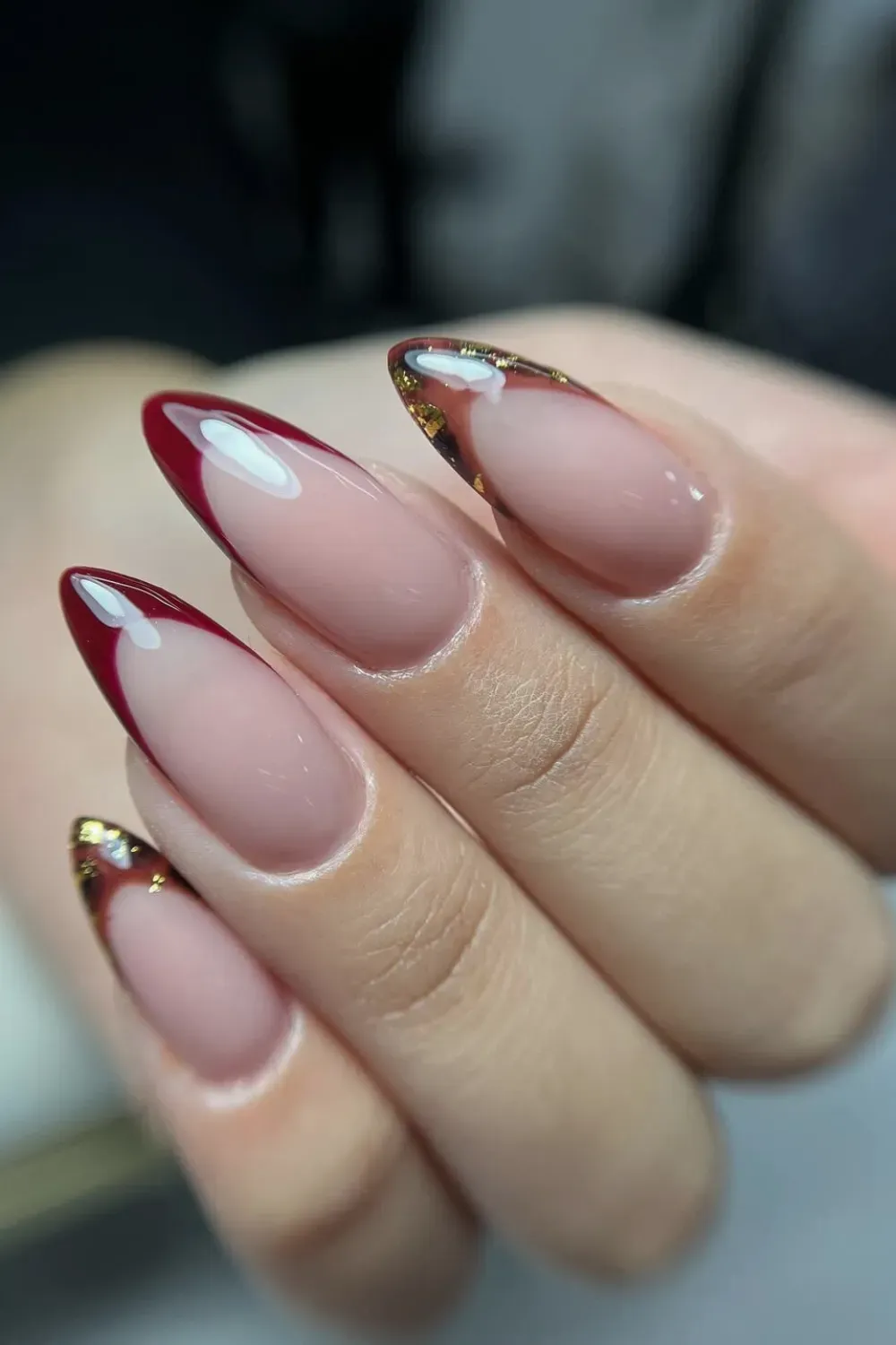 Autumnal Red & Gold Leaf French: Almond nails with deep red French tips and shimmering gold leaf details