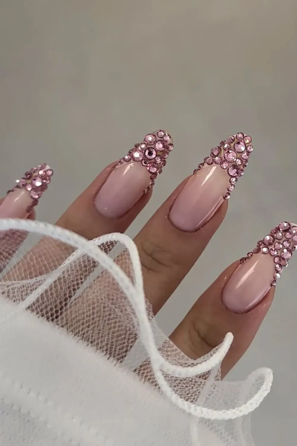 Pink Rhinestone French Tips Alt Text: Nude nails with full 3D pink rhinestone french tips.
