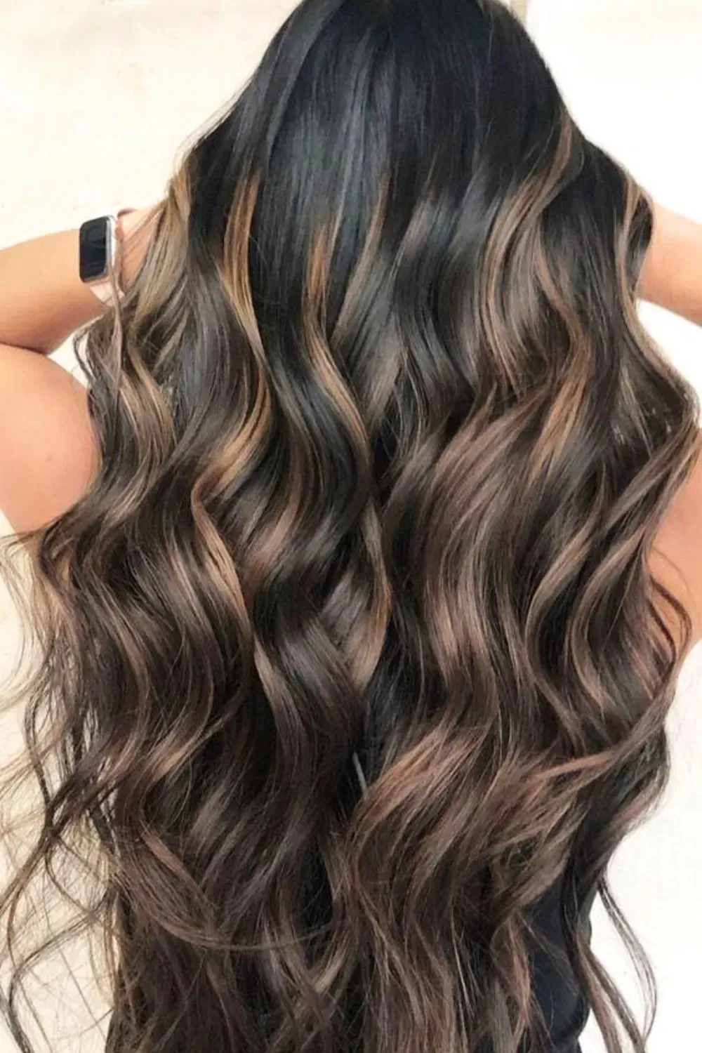 Low-Maintenance Shadow Root Caramel Balayage	Back view of long, messy waves with soft caramel balayage melting from a dark shadow root.