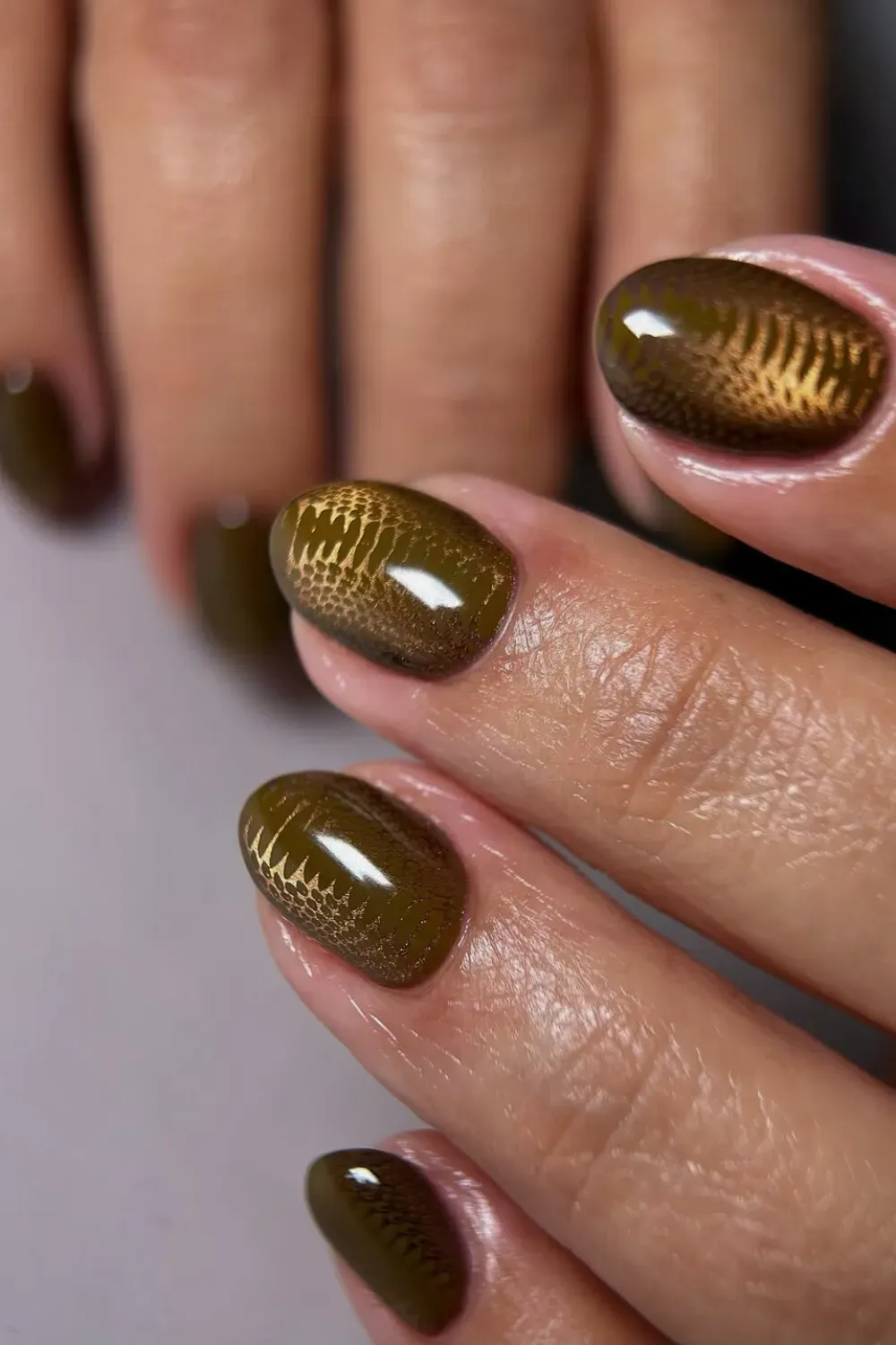Olive green magnetic polish with 3D reptile skin texture on short square nails.