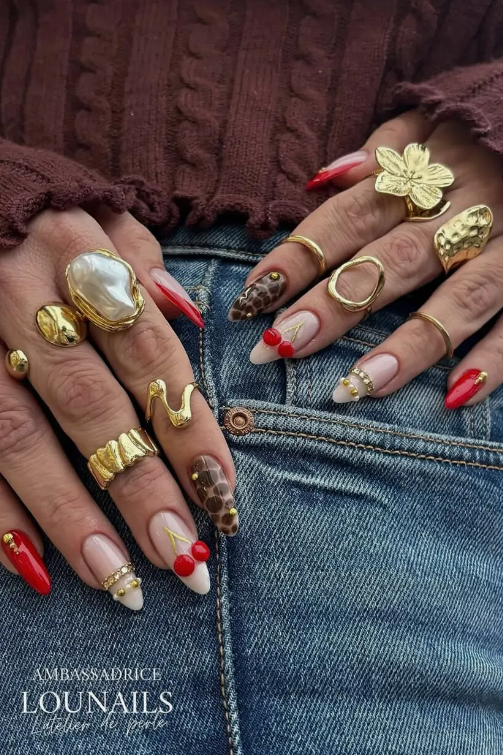 Red & Cherry Bangle Nails with Animal Print and Gold Rings - Playful Jewelry Nail Art set featuring red tips, 3D cherries, leopard spots, and stacked gold Bangle Nail bands on a long almond shape.
