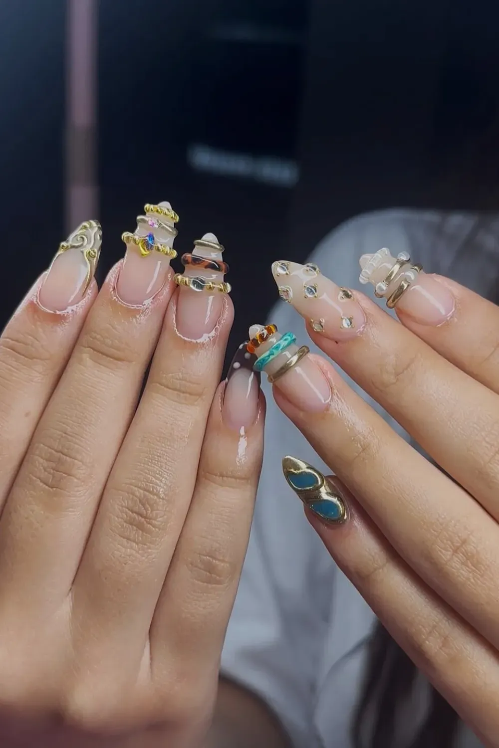 Detailed 3D Bangle Nails with Mixed Color Bands and Jewels - Close-up of clear Bangle Nail set with mixed color rings, embedded rhinestones, and high-quality gold 3D texture.