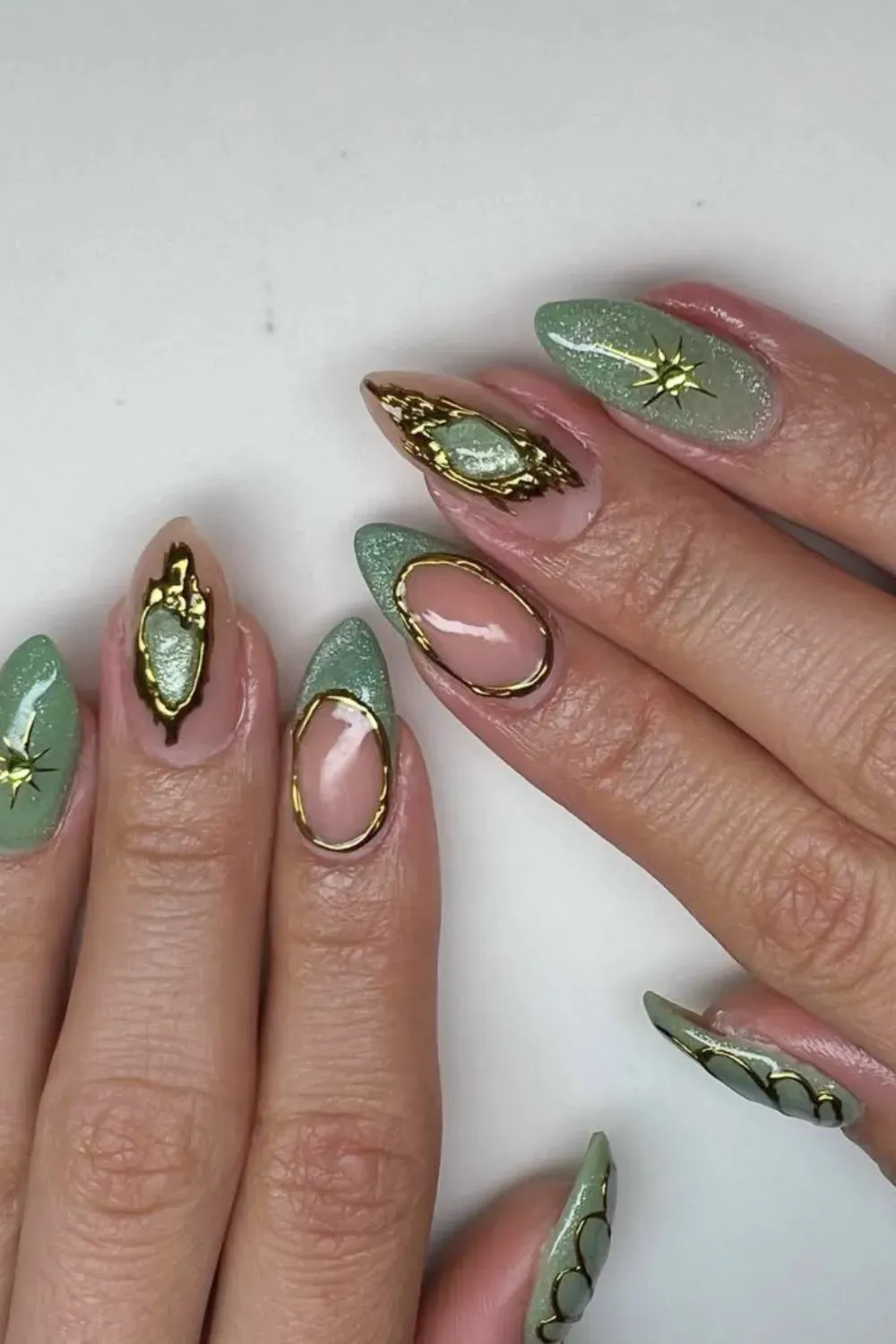Celestial Sage Green Structured Gel Nails - Long stiletto nails with shimmering sage green and 3D gold celestial hardware.