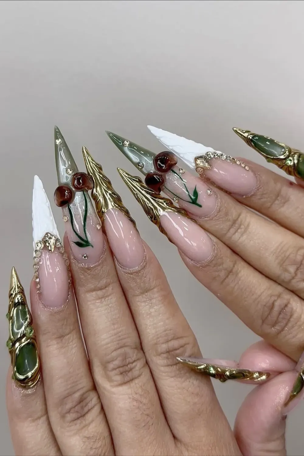 Avant Garde Cherry Nail Art Alt Text: Extreme stiletto nails with white texture and large 3D cherries.