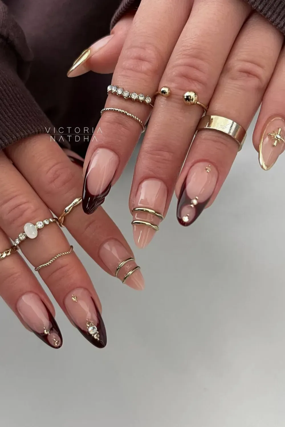 Chic Brown French Tip Bangle Nails with Wrapped Gold Rings - Long, coffin-shaped Bangle Nail design with dark brown French tips and multiple thin, gold 3D bands wrapped around the nail center.