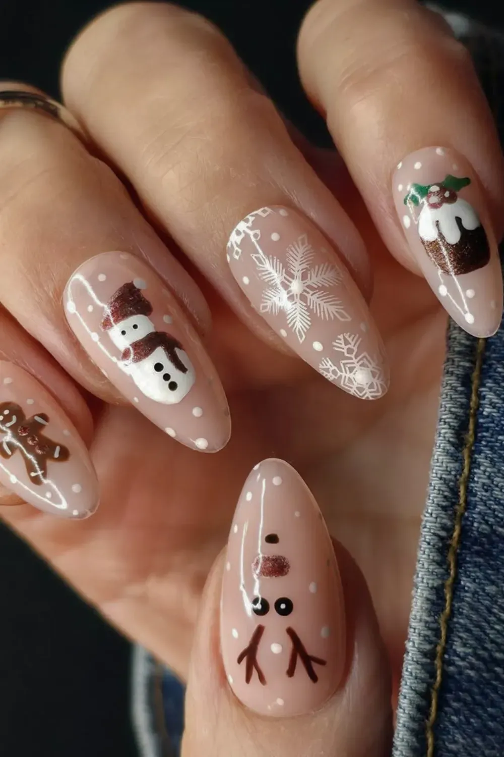 Nude Nails with Christmas Character Art - Almond nails with a nude base and hand-painted gingerbread man, snowman, and reindeer