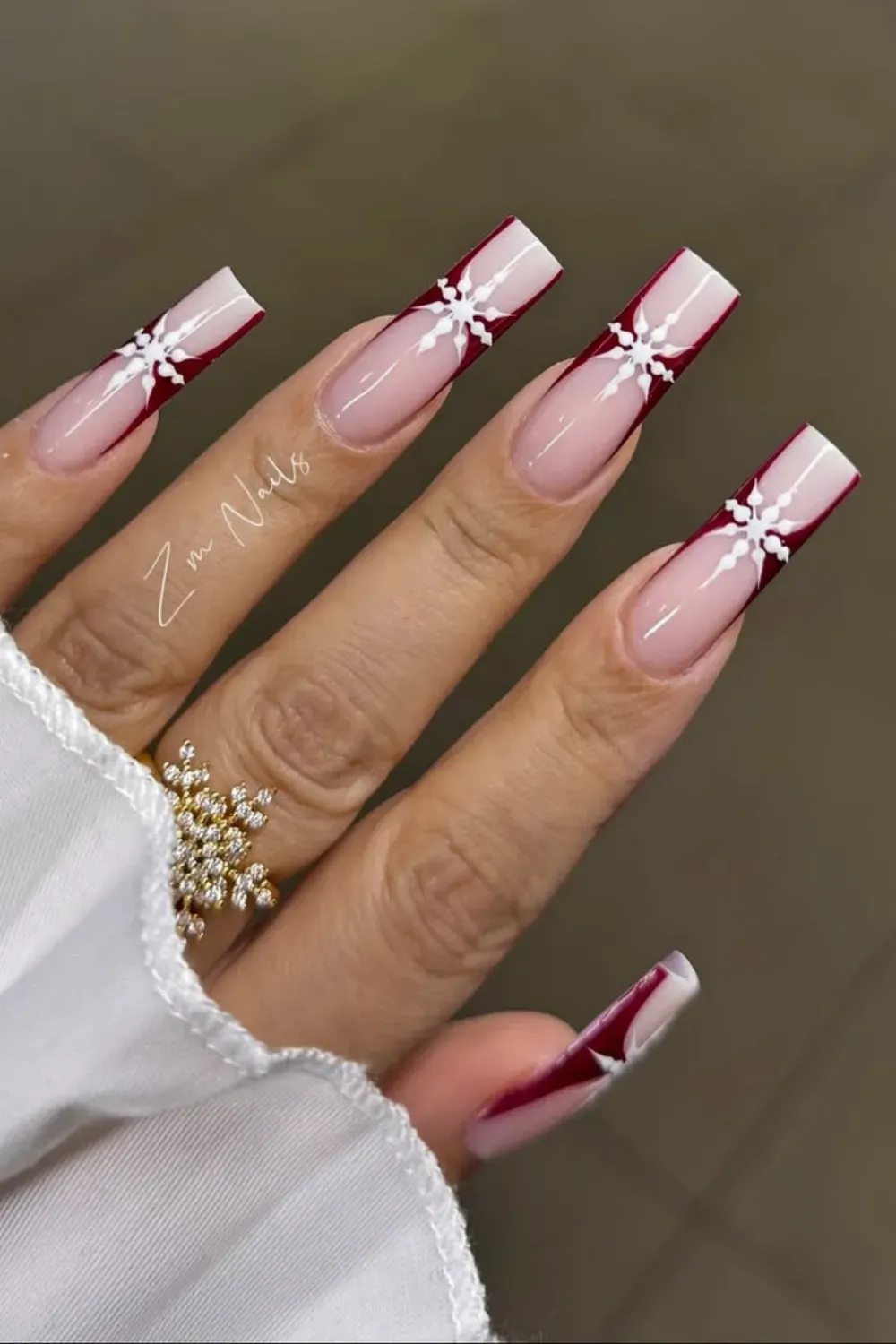 Bold Red French Coffin Nails with Snowflakes - Long coffin nails featuring dramatic red French tips with large white snowflake designs