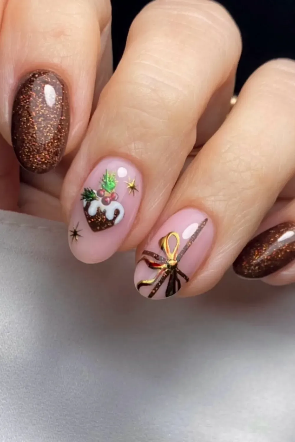 Pink Nails with Christmas Pudding and Gift - Oval nails with a pink base featuring hand-painted Christmas pudding and gift art