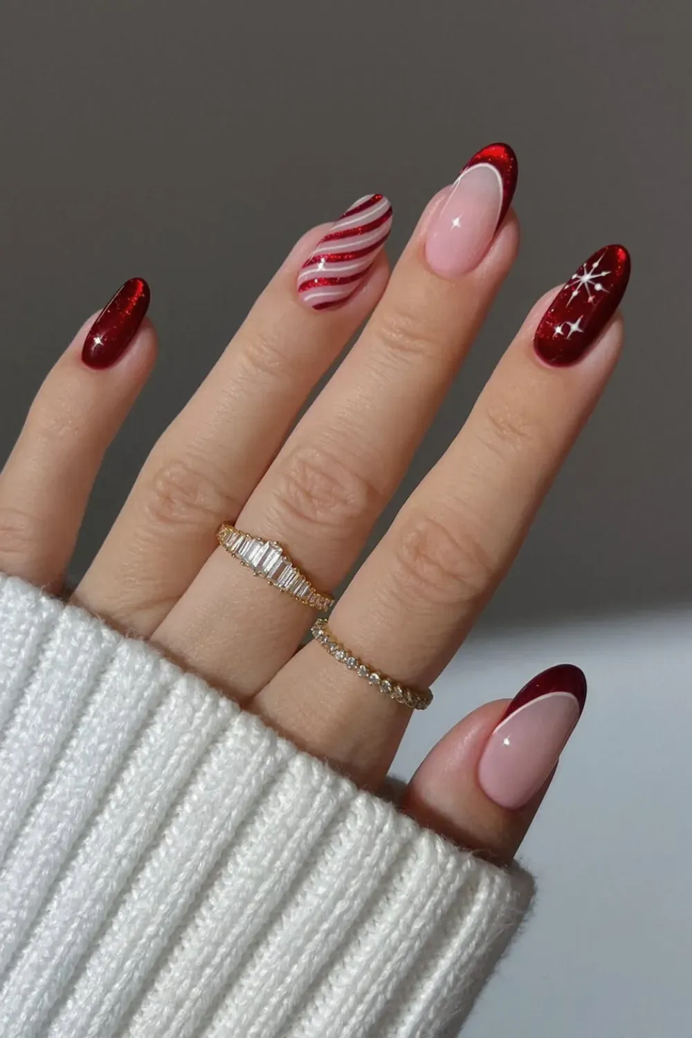 Red Glitter and Candy Cane Stripe Almond Nails - Almond nails with a mix of full red glitter and festive red and white candy cane stripes
