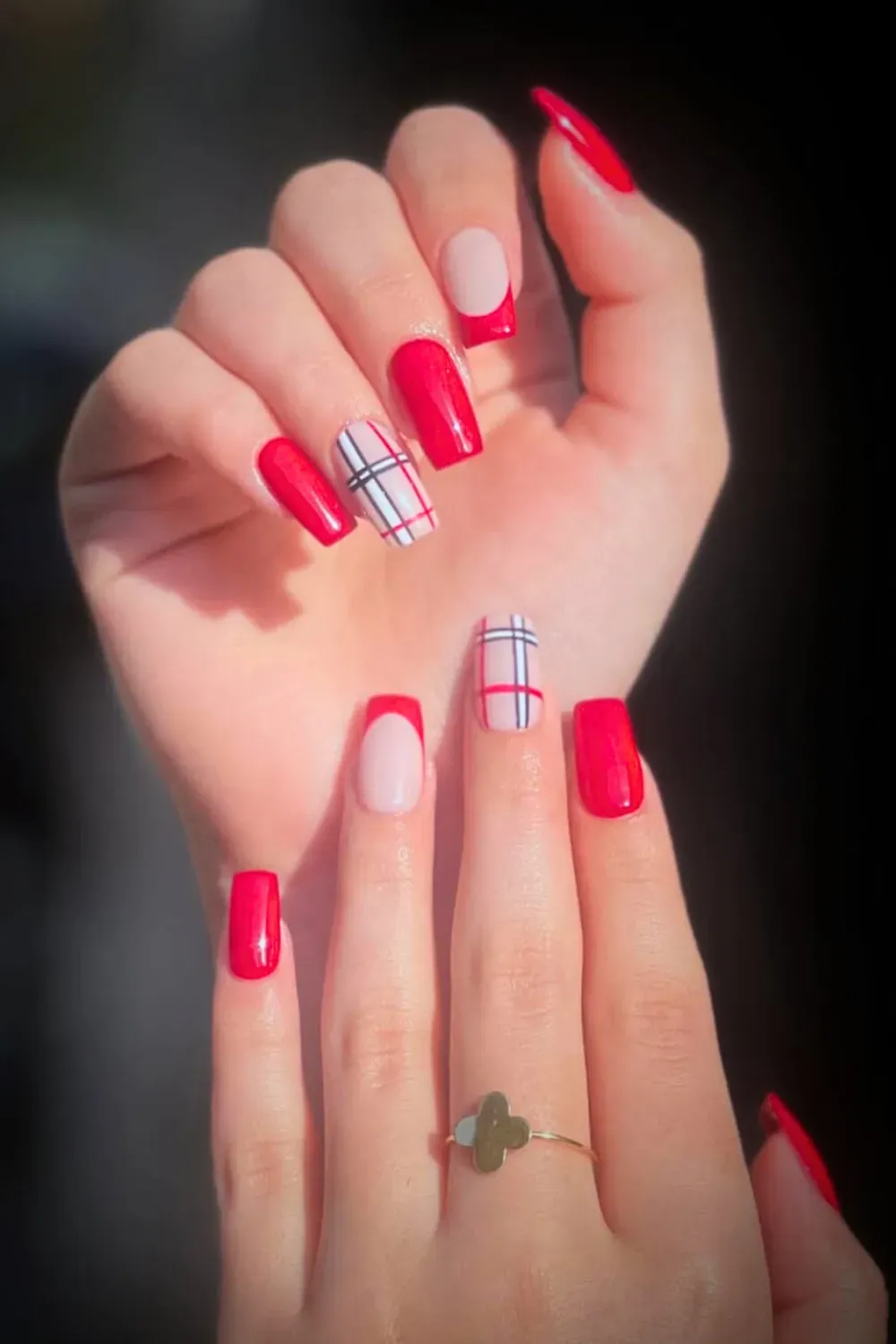Red and Nude Plaid Coffin Nails - Coffin nails with a mix of glossy red nails and nude nails with a classic red plaid pattern.