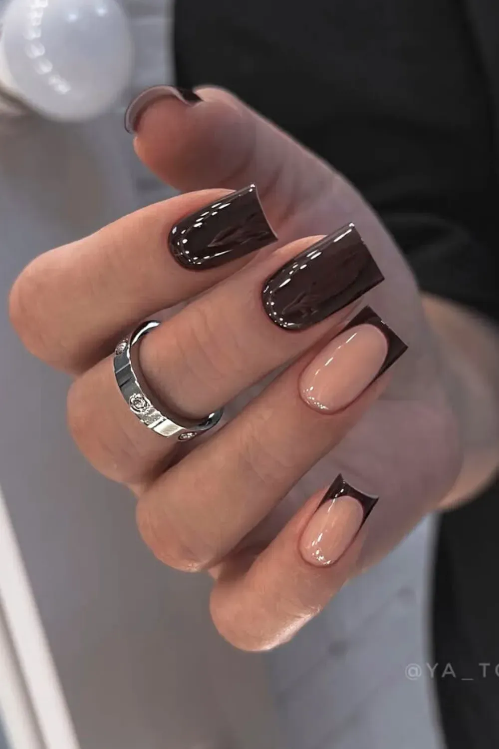 Architectural Dark Brown French Tips	Hand showing long, squared nails with a nude base and a bold, straight/angular dark brown French tip