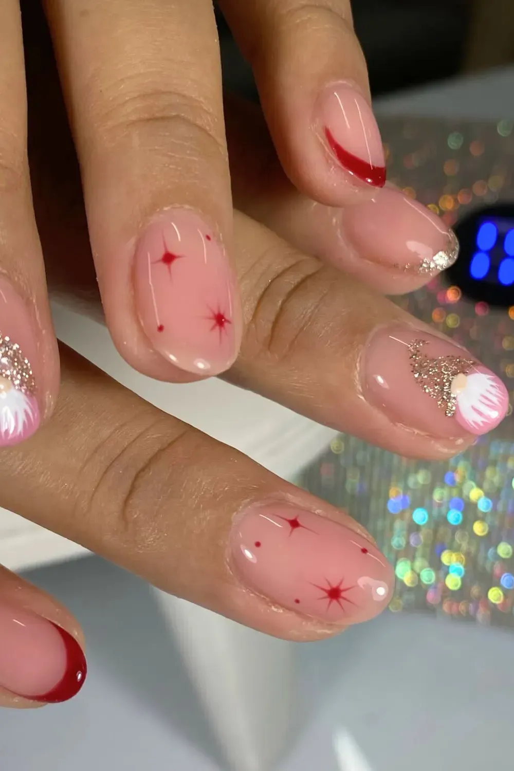 Cute Gnome and Red Star Oval Nails - Short oval nails with a hand-painted gnome and simple red stars on a pink base