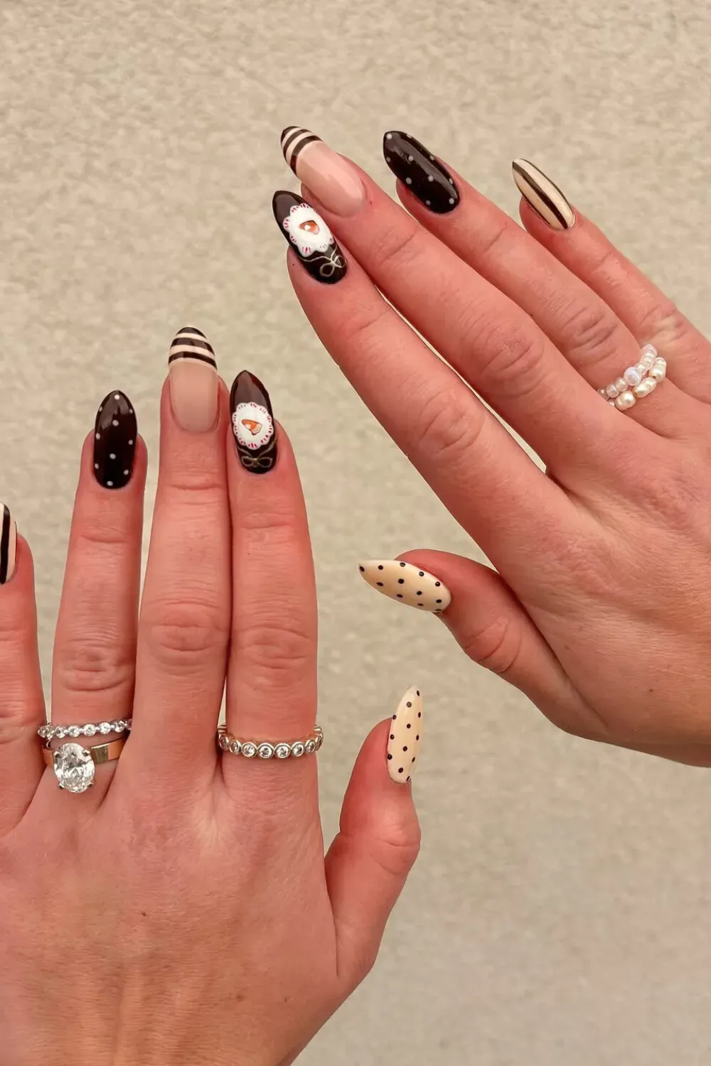 Elegant Chocolate and Cream Dot & Stripe Nails Long, almond-shaped nails with a mix of chocolate brown and cream, featuring polka dots, stripes, and a "whipped cream" floral accent.