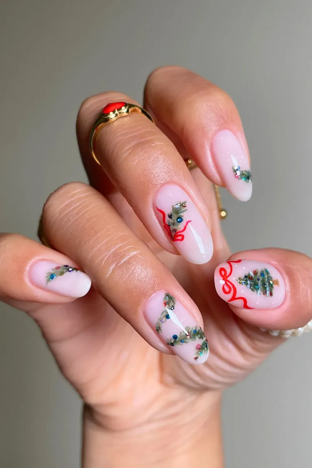 White Nails with Evergreen Branches and Berries - Almond nails with a sheer white base and delicate hand-painted evergreen branches with red berries.