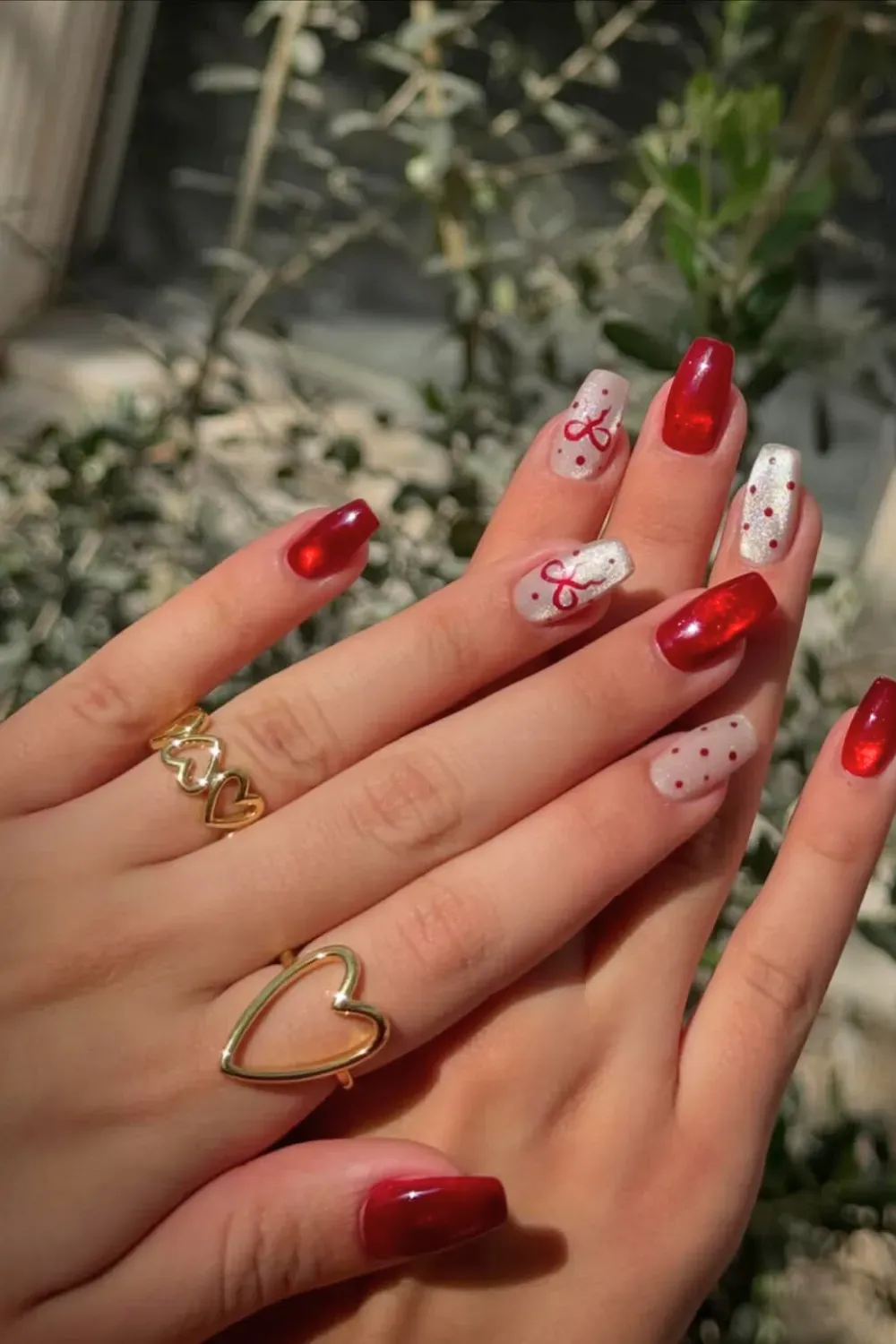Red Glitter and Bow Coffin Nails - Coffin nails with a mix of red glitter and sheer nude with red polka dots and bows.
