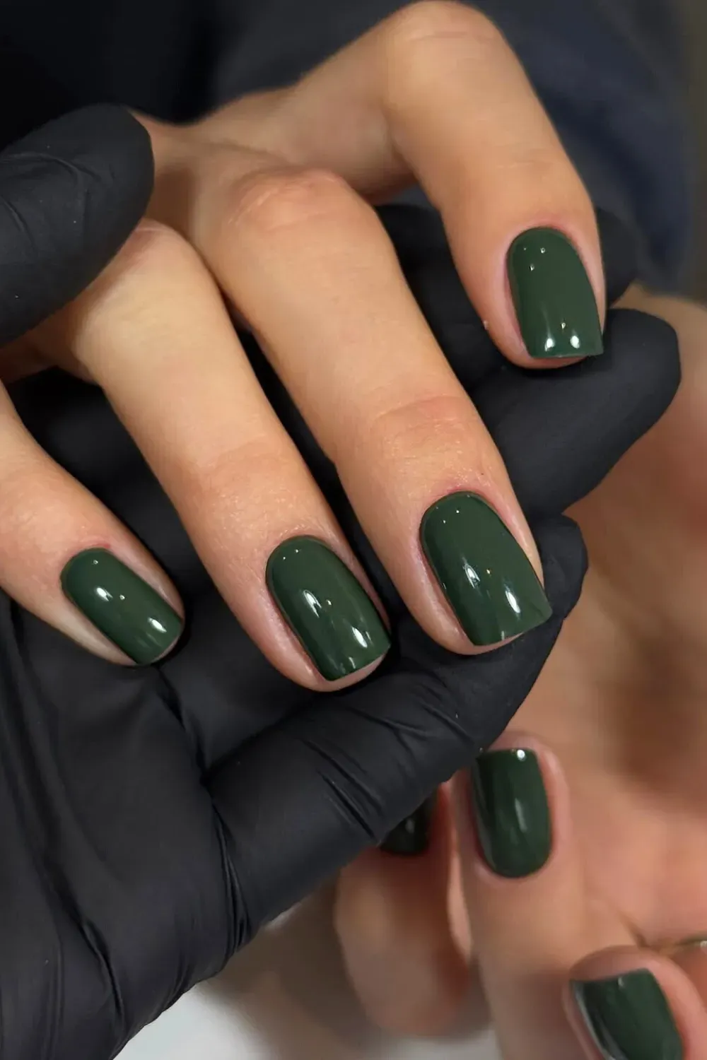Lush Deep Forest Green Nails	Hands (one wearing black gloves) showcasing short, rounded-square nails in a flawless, solid forest green.
