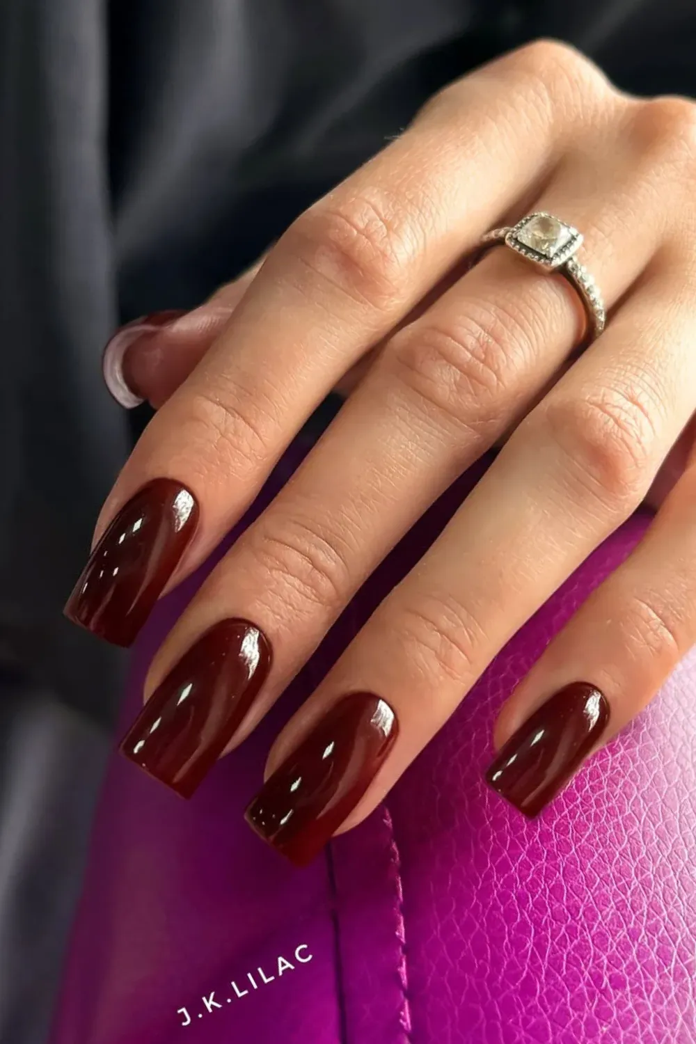 High-Gloss Vampy Burgundy Nails	Close-up of long, squared nails in a deep, highly-glossy burgundy color.