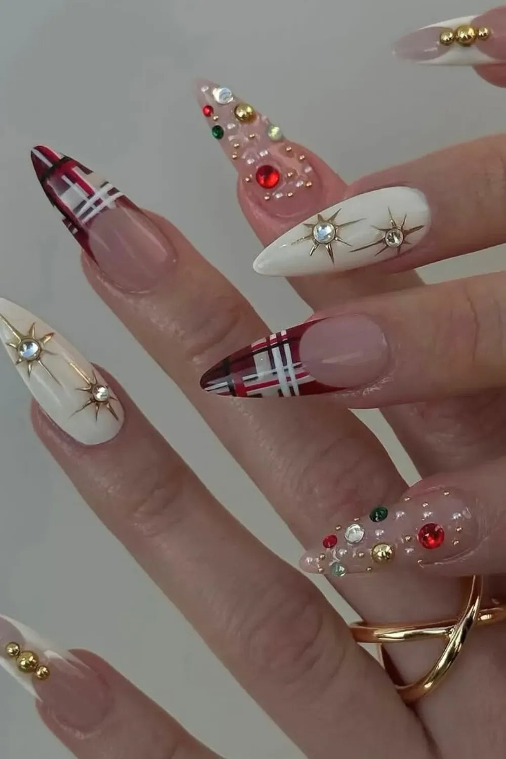 Maximalist Plaid and Gem Star Stiletto Nails - Stiletto nails with a mix of plaid patterns and white nails with large gold gem stars