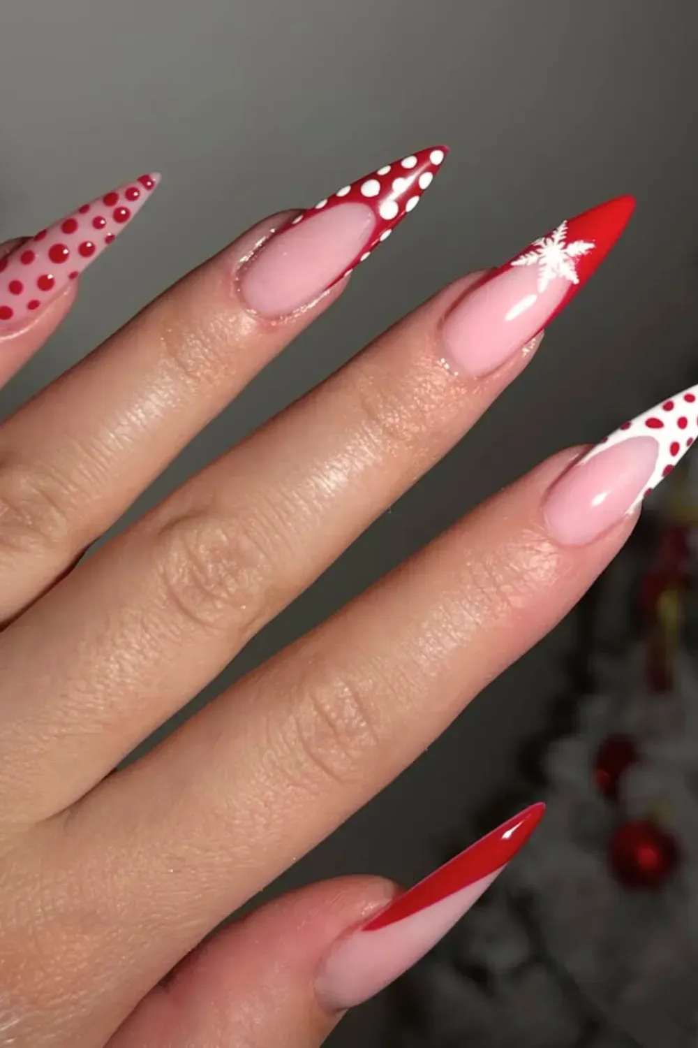 Red and White Polka Dot French Tip Nails - Stiletto nails with red and white polka dot French tips and a single snowflake.