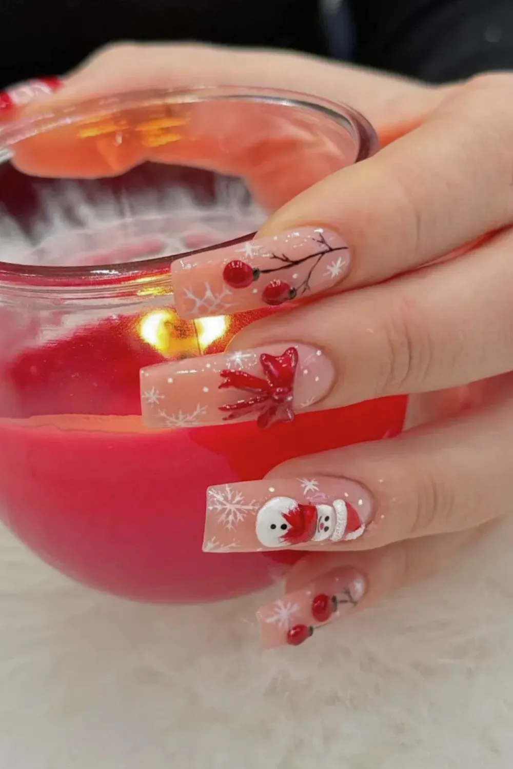 Long Square Nails with Red Berries and Snowman - Long square nails with a sheer pink base, red berries, a bow, and a snowman design.