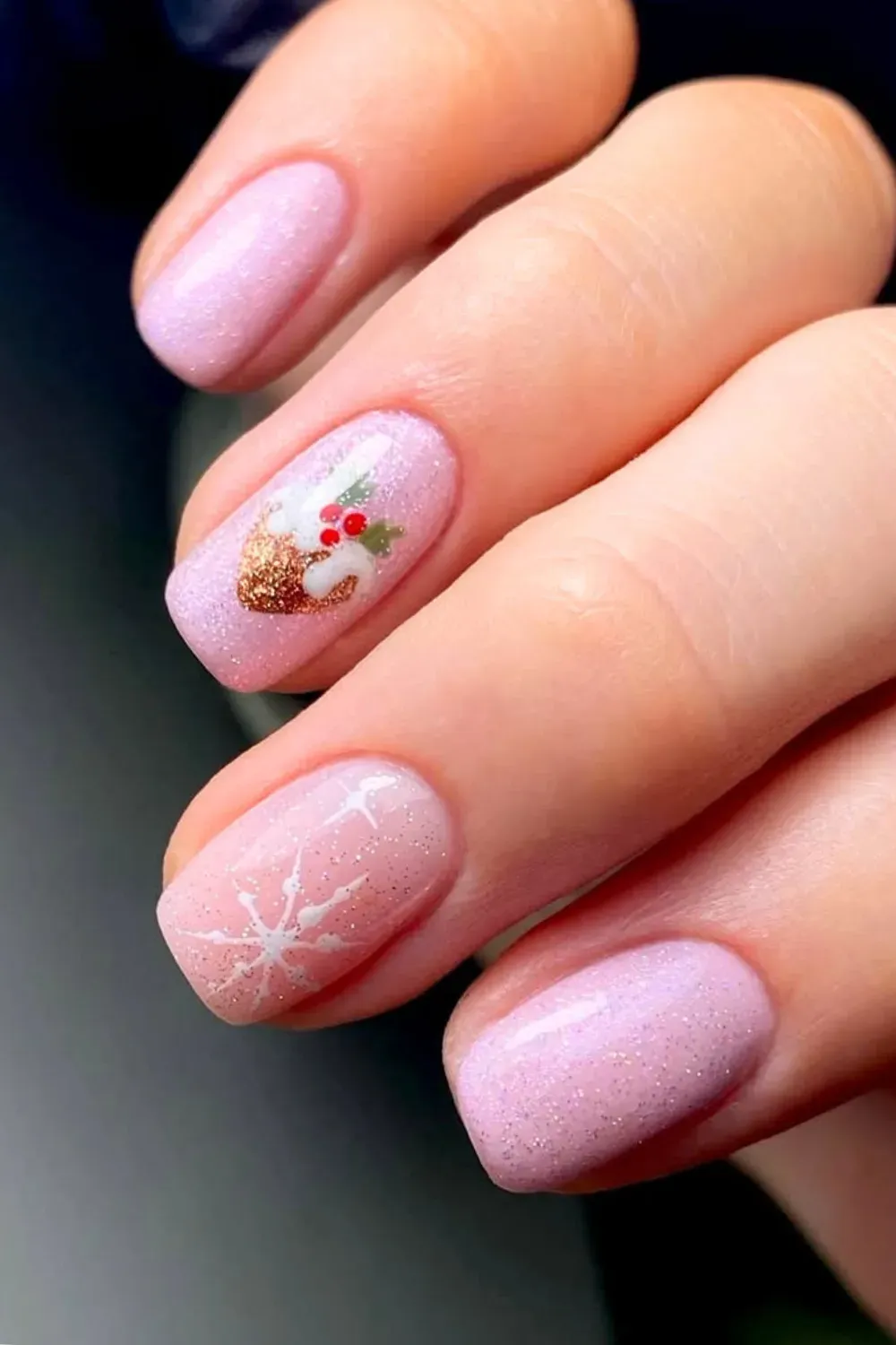 Pink Nails with Glitter Pudding and Snowflake - Short oval nails with a pink base, a glittery Christmas pudding, and a white snowflak