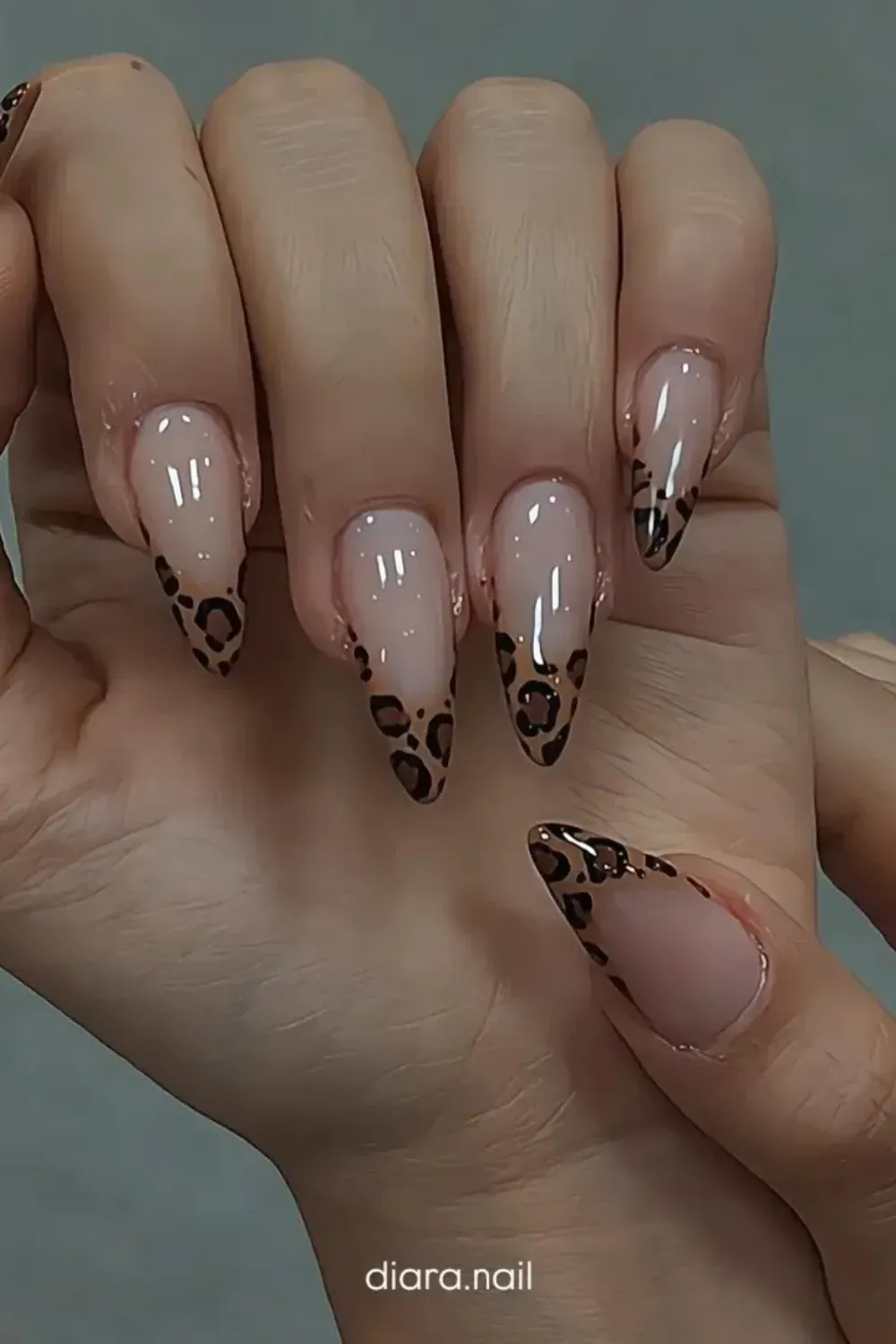 Leopard Print V-Tip Almond Nails Almond-shaped nails with a nude base and a fierce, high-V French tip design done in classic leopard print.