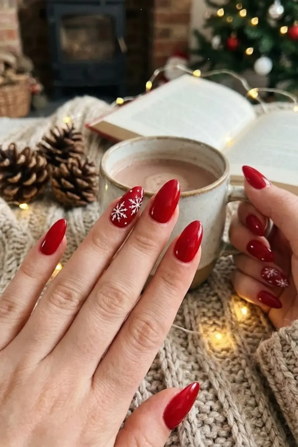 Classic Red Almond Nails with White Snowflakes - Glossy red almond nails featuring delicate hand-painted white snowflakes for a traditional Christmas manicure.