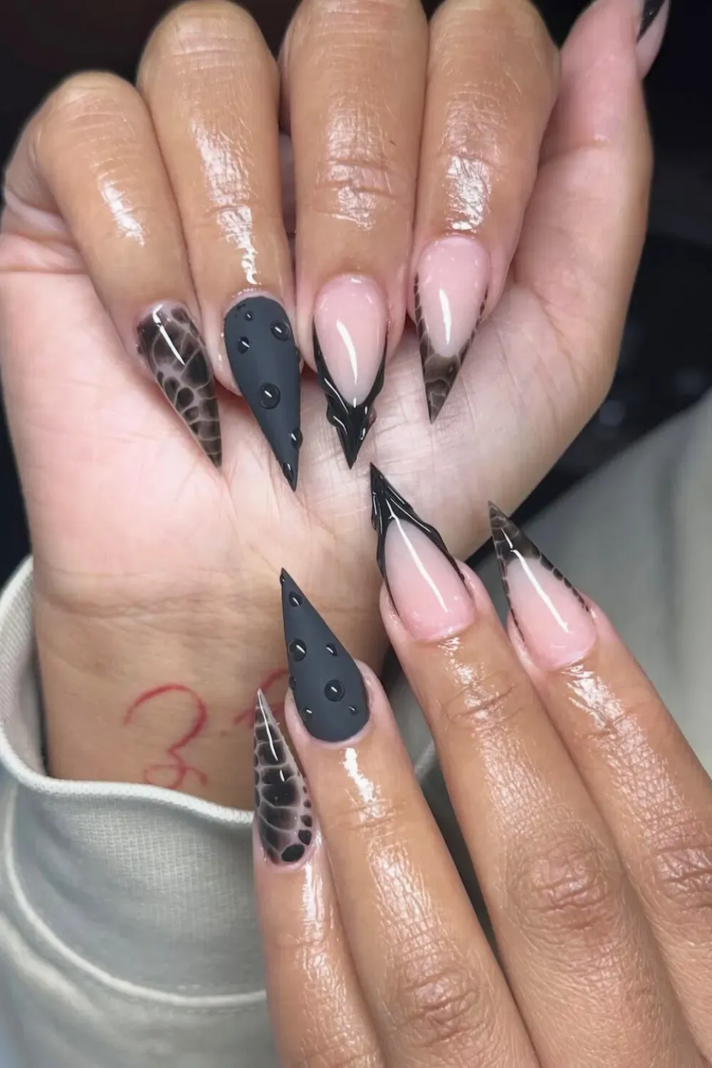 Matte Black Croc Stilettos	Black stiletto nails with matte croc print and 3D water droplets