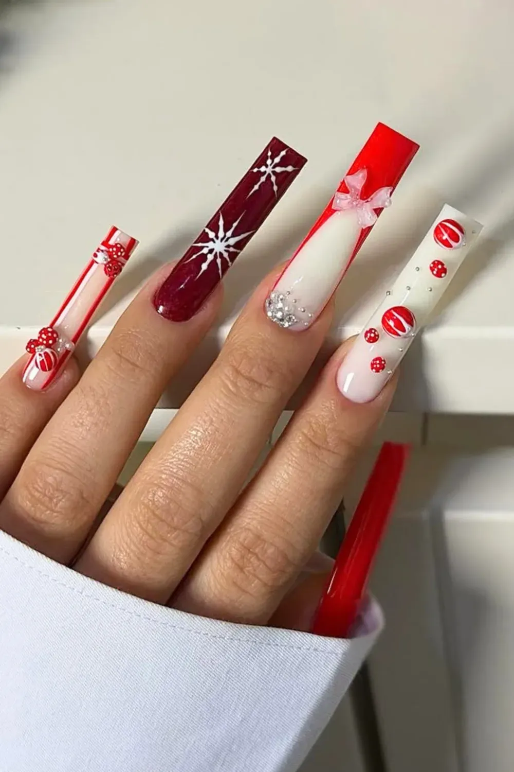 Long Coffin Red and Silver Ornament Nails - Long coffin nails featuring red and burgundy polish with 3D silver baubles and candy cane texture.