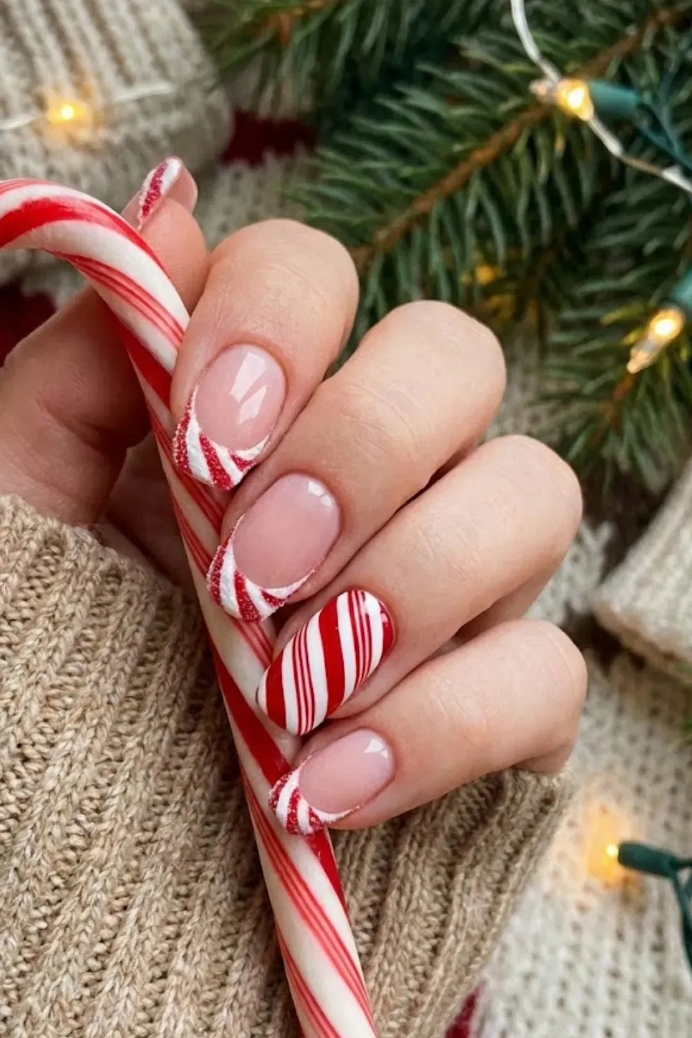 Candy Cane Striped French — French tips painted in red and white candy cane stripes with glitter outline.