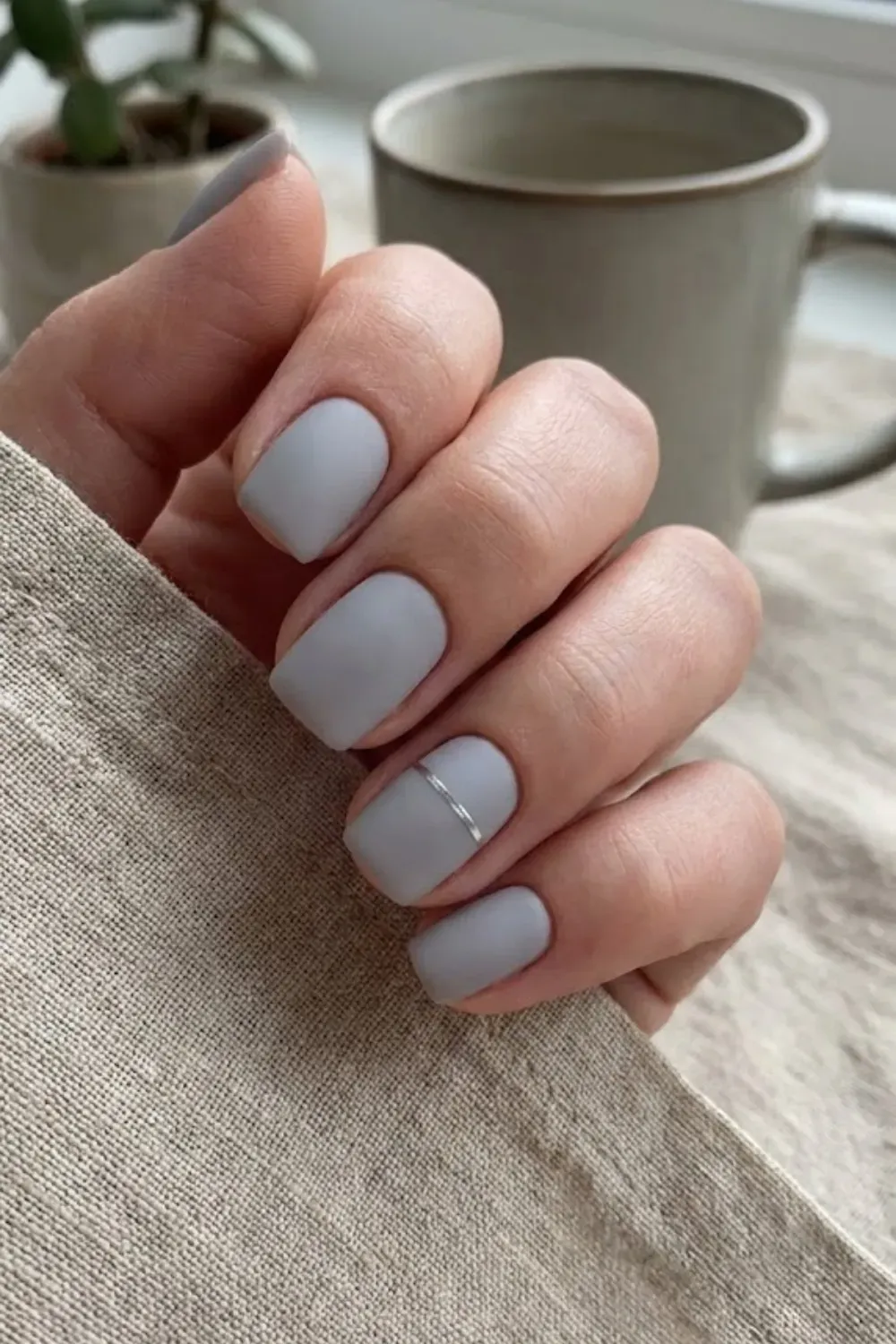 Matte Grey Silver Strip – Square matte grey nails accented with a thin silver horizontal strip foil.
