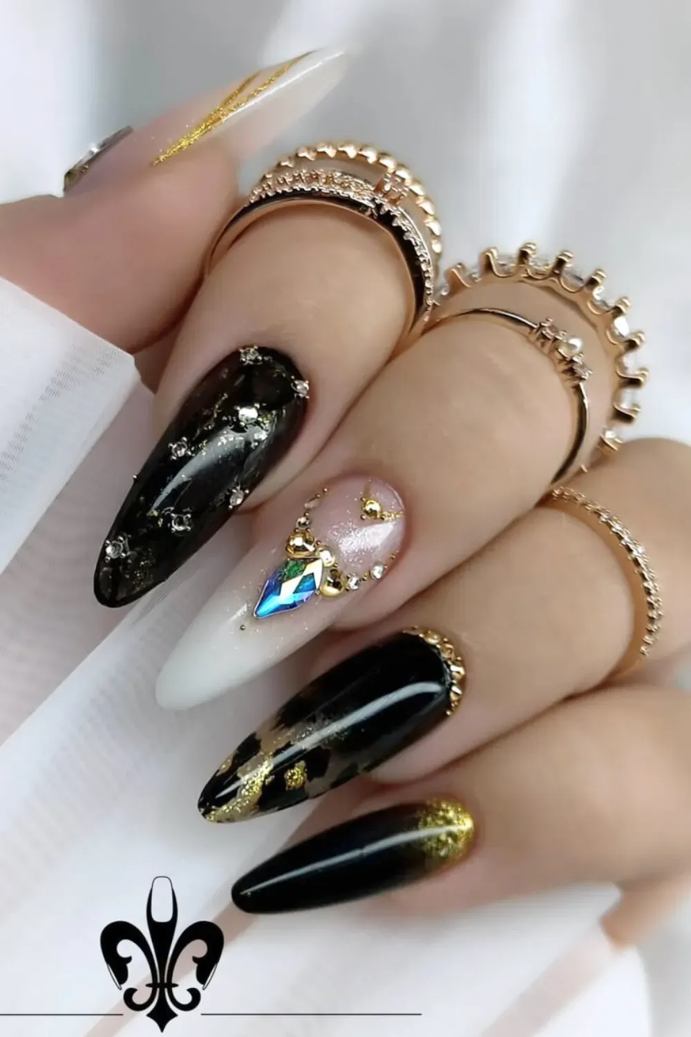 Opulent Black and Gold Marble	Almond nails with black marble, gold leaf and large gem
