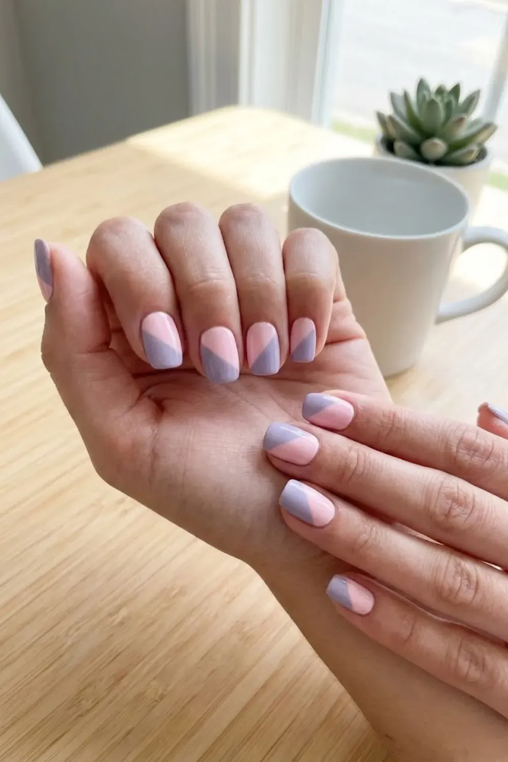 pastel-color-block-nails-pink-lavender. - Short nails with pastel color block design using soft pink and lavender shades.