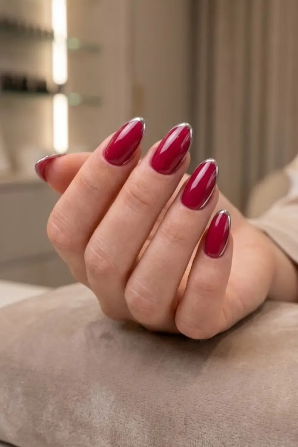 Berry Red with Silver Chrome Tips – Almond-shaped nails featuring a deep berry red base color with metallic silver chrome french tips.