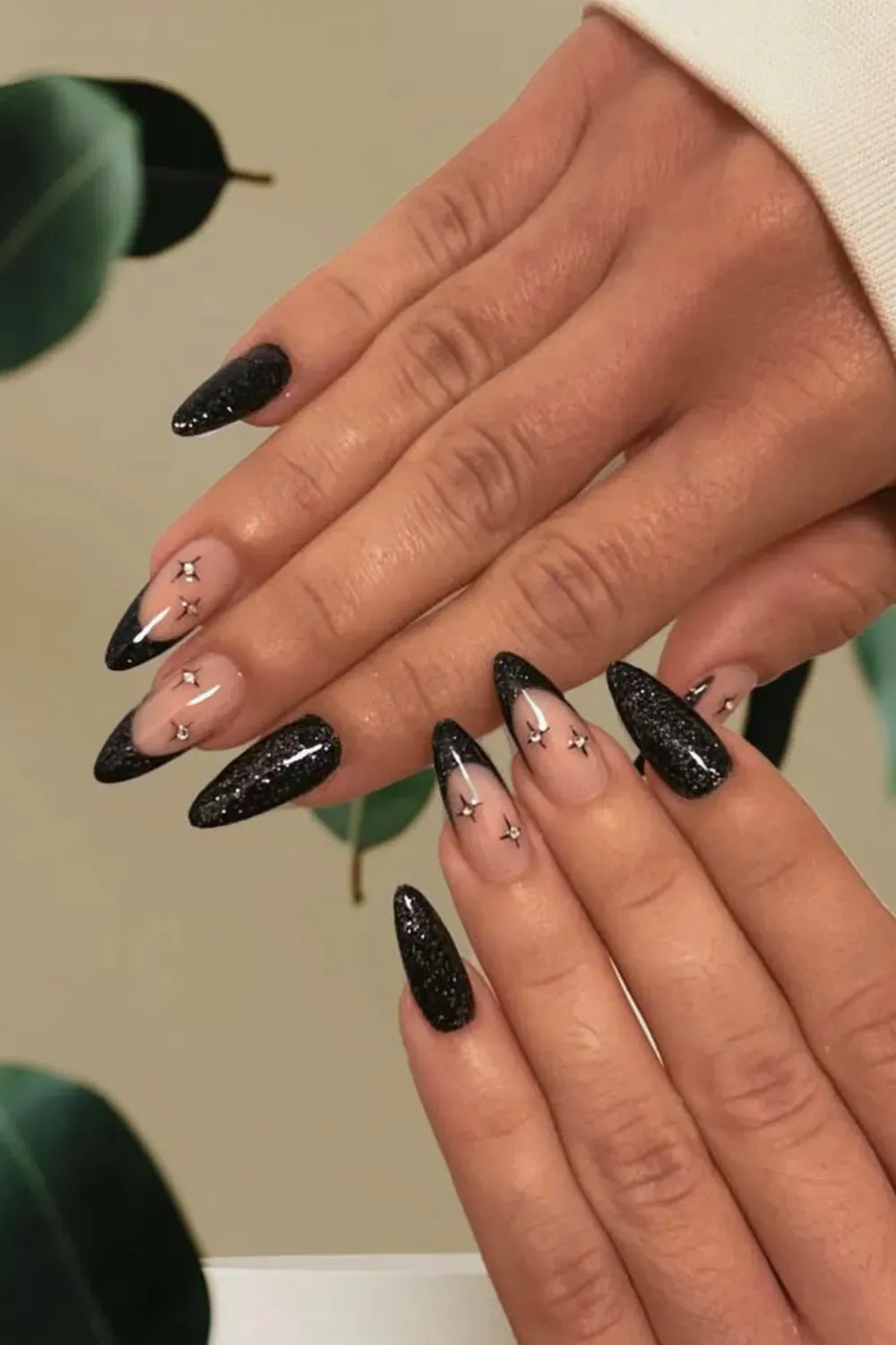 Celestial Glam French Glitter	Almond nails with black french tips, stars and black glitter