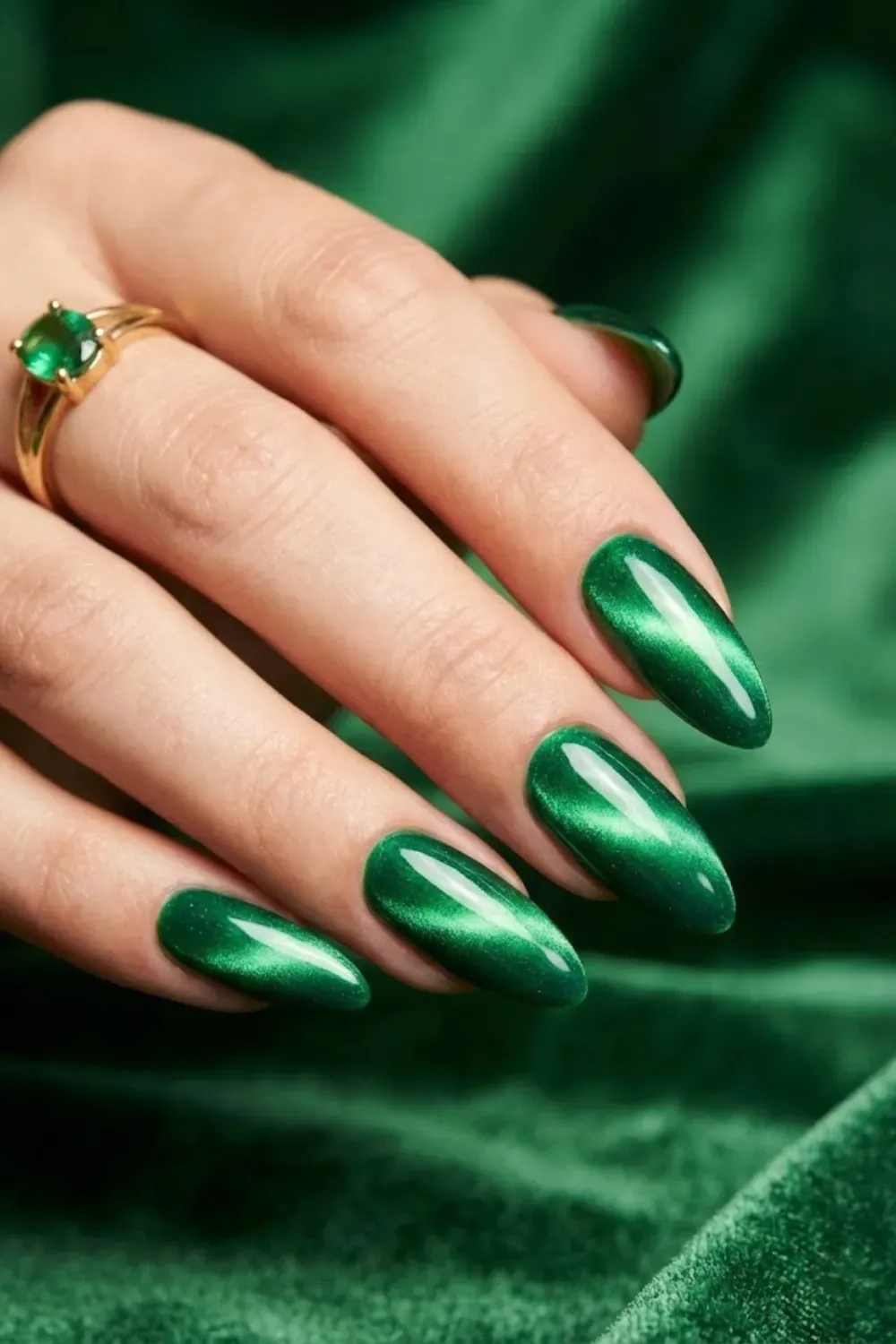 Emerald green cat eye nails with gemstone-inspired magnetic center