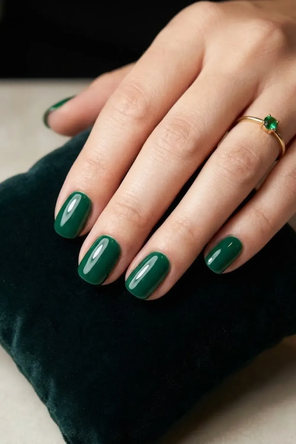 Deep Emerald Glossy Round - Elegant short round nails coated in a deep emerald green glossy polish, looking luxurious and high-end.