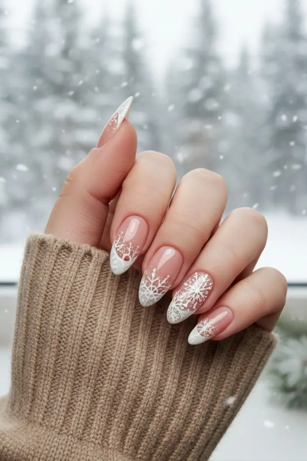 Snowflake French Manicure - Hand by a snowy window showing a classic French manicure embellished with delicate white snowflakes on the tips